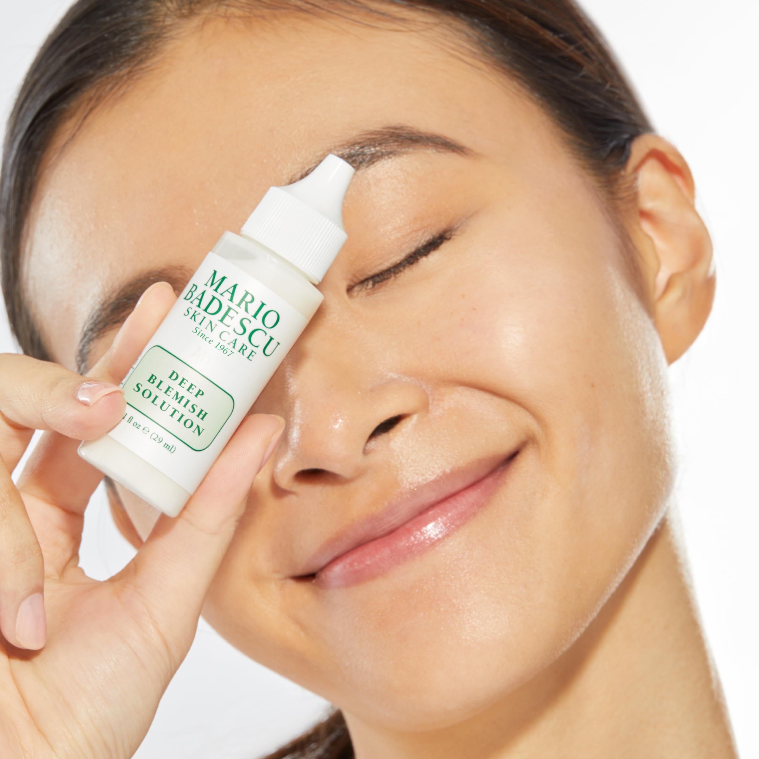 Close-up of Mario Badescu Deep Blemish Solution texture absorbing into skin.