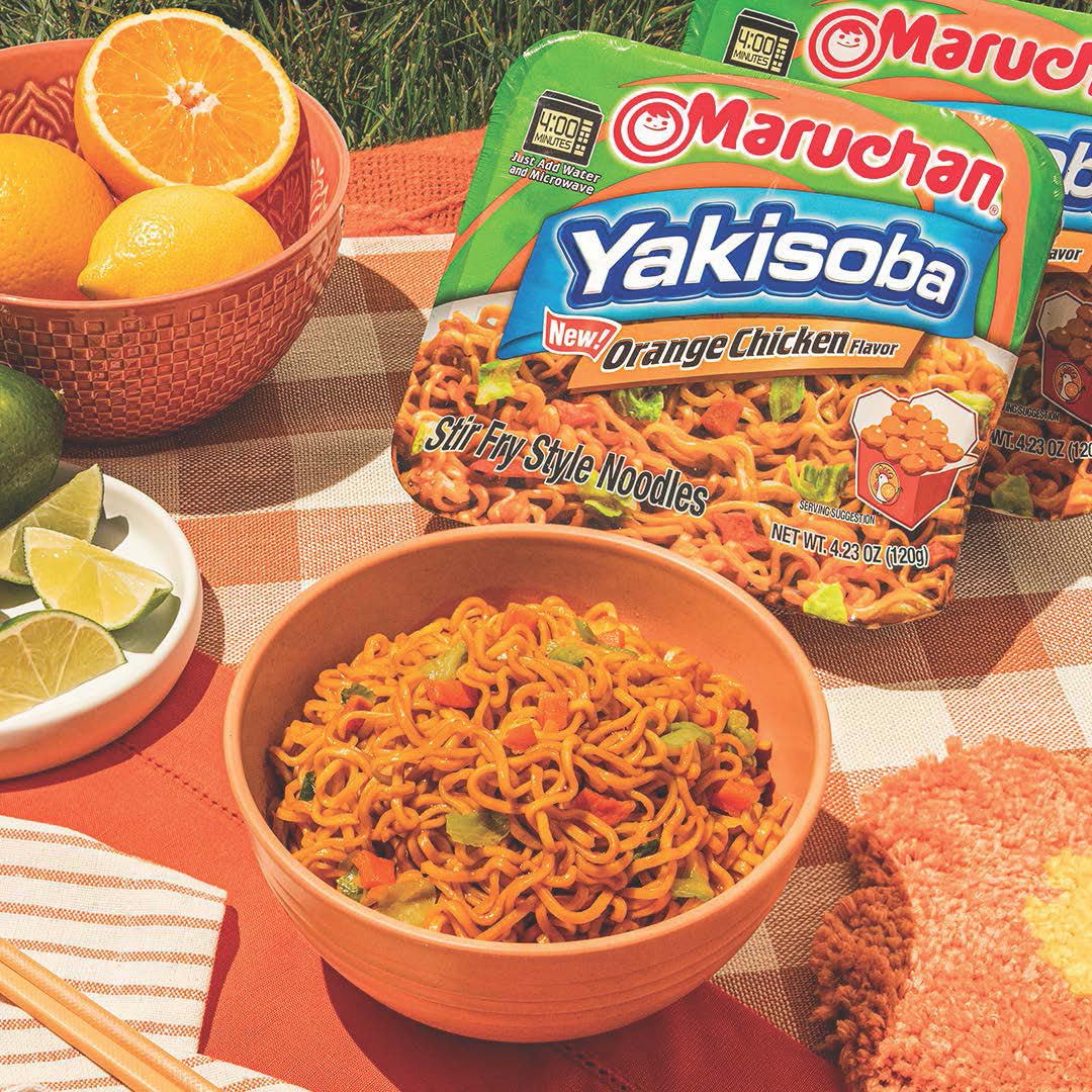 Maruchan Yakisoba Orange Chicken with cabbage and carrots garnish, colorful crunch.