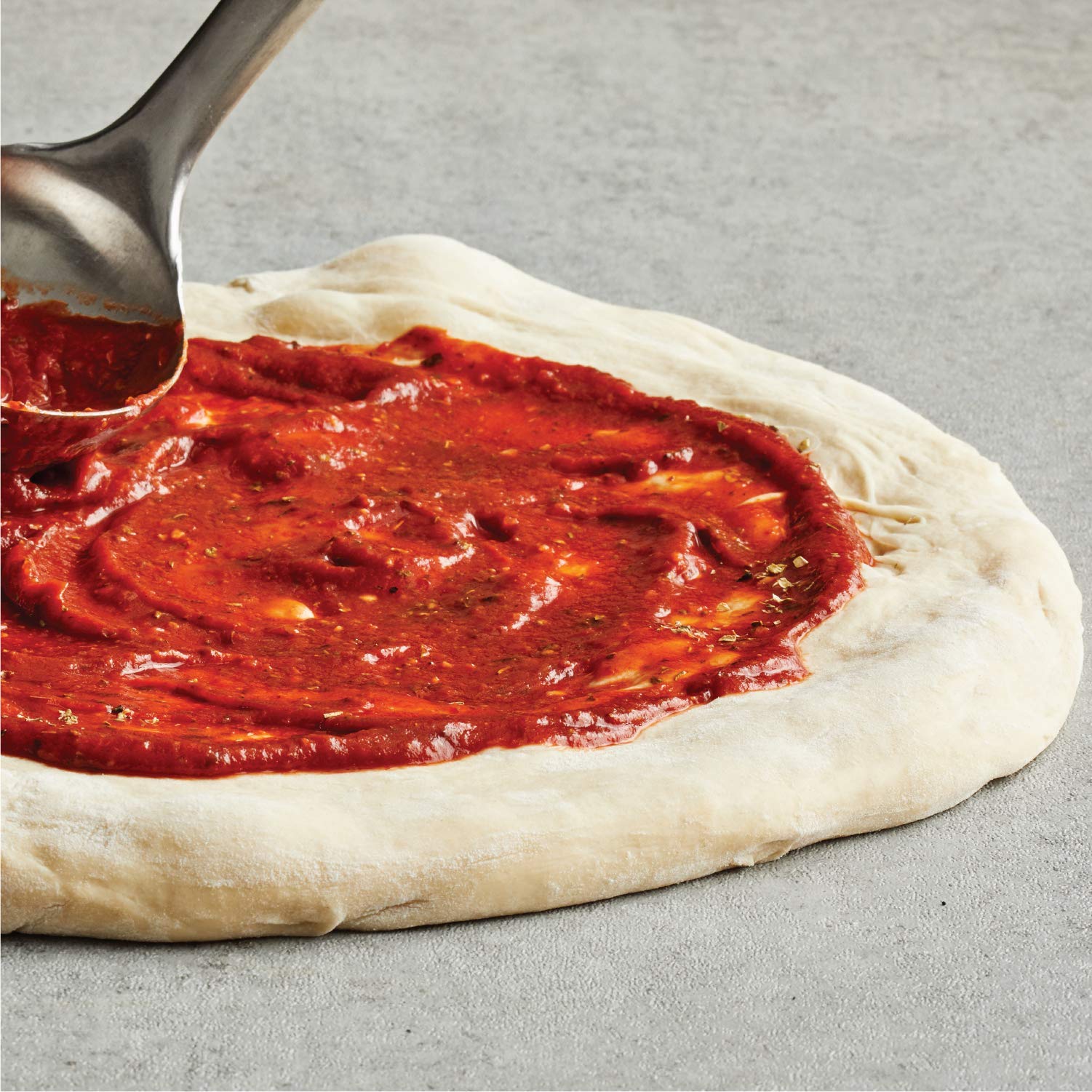 Crushed red pepper on a pepperoni pizza