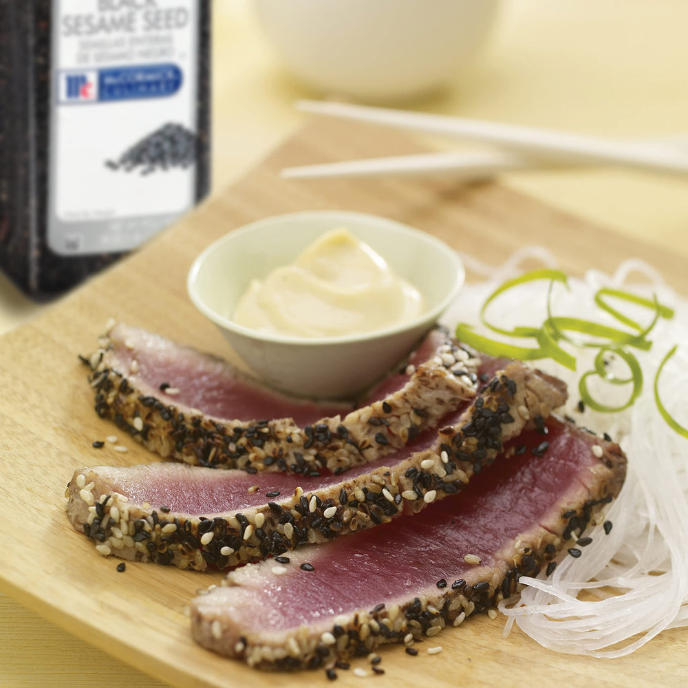 Garnishing sushi rolls with McCormick Culinary black sesame seeds for contrast