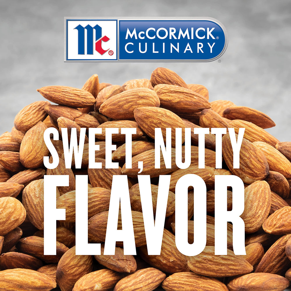 McCormick Culinary imitation almond extract being poured for precise flavoring in large batches.
