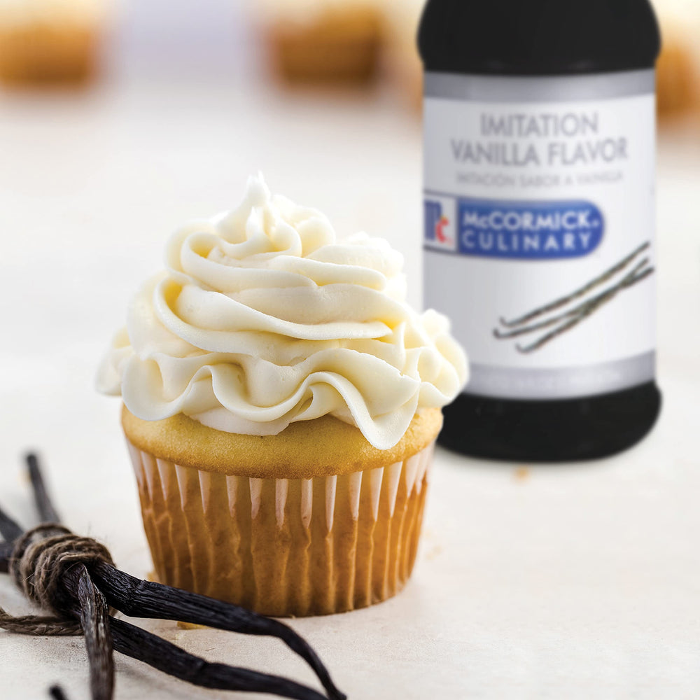 McCormick Culinary imitation vanilla on dessert plate; enhances flavors in sweet treats.