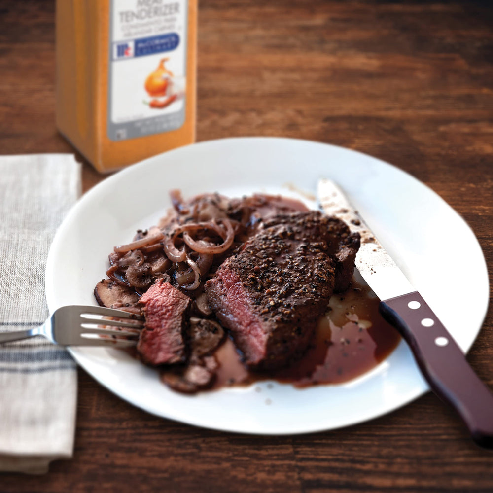 Beef being grilled after seasoning with McCormick Culinary Tenderizer.