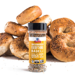 Sprinkling McCormick Everything Bagel All-Purpose Seasoning on avocado toast for crunch.