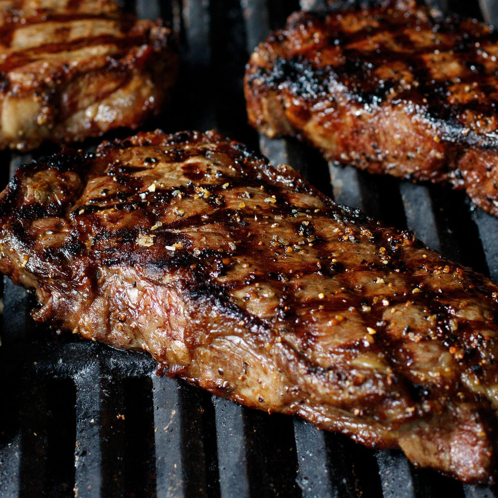 Grilling steak with Montreal Seasoning rub from McCormick Grill Mates.