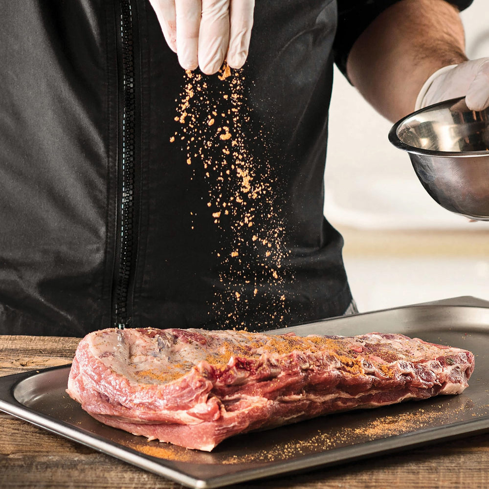 McCormick Grill Mates Smokehouse Maple being used as a dry rub on meat.