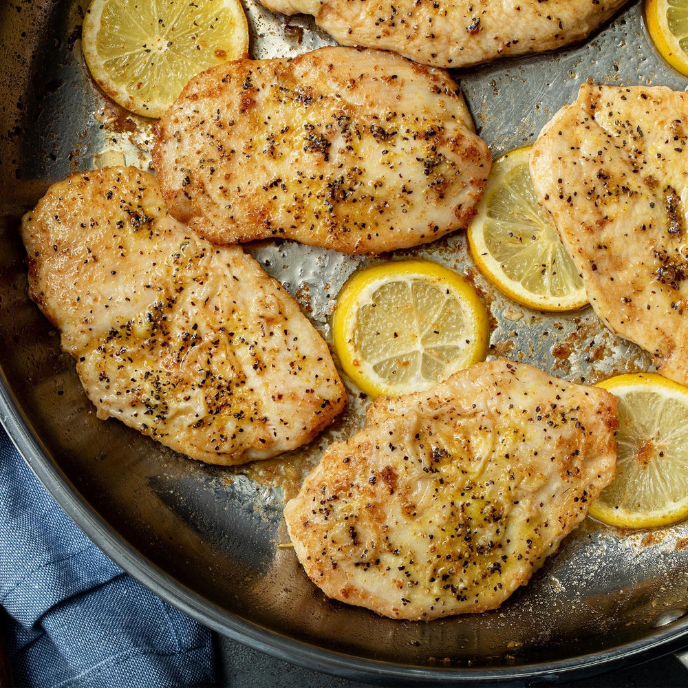 Closeup of McCormick Perfect Pinch Lemon Pepper on seafood ready for grilling.