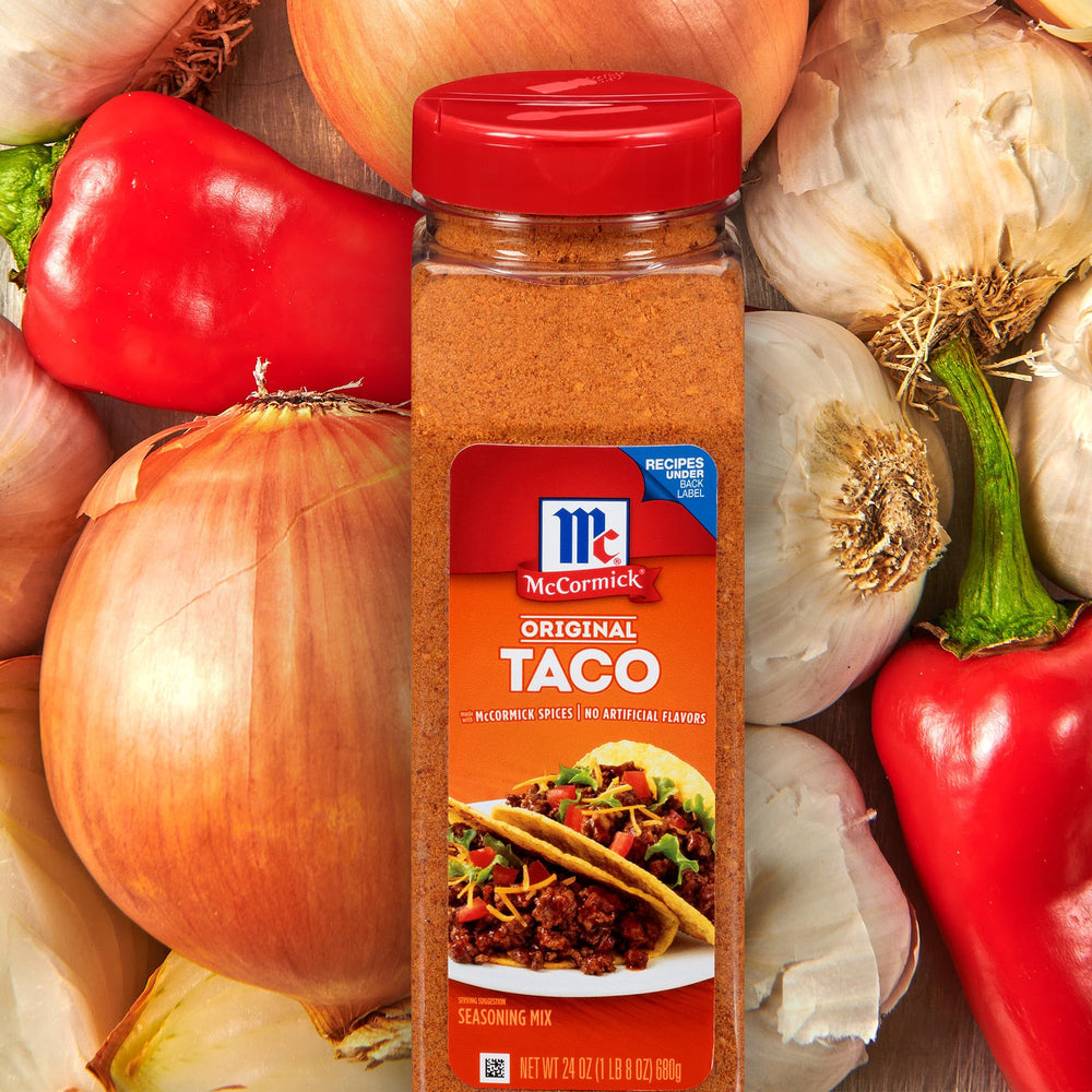 Measuring spoon over a dish ready for McCormick Original Taco Seasoning.