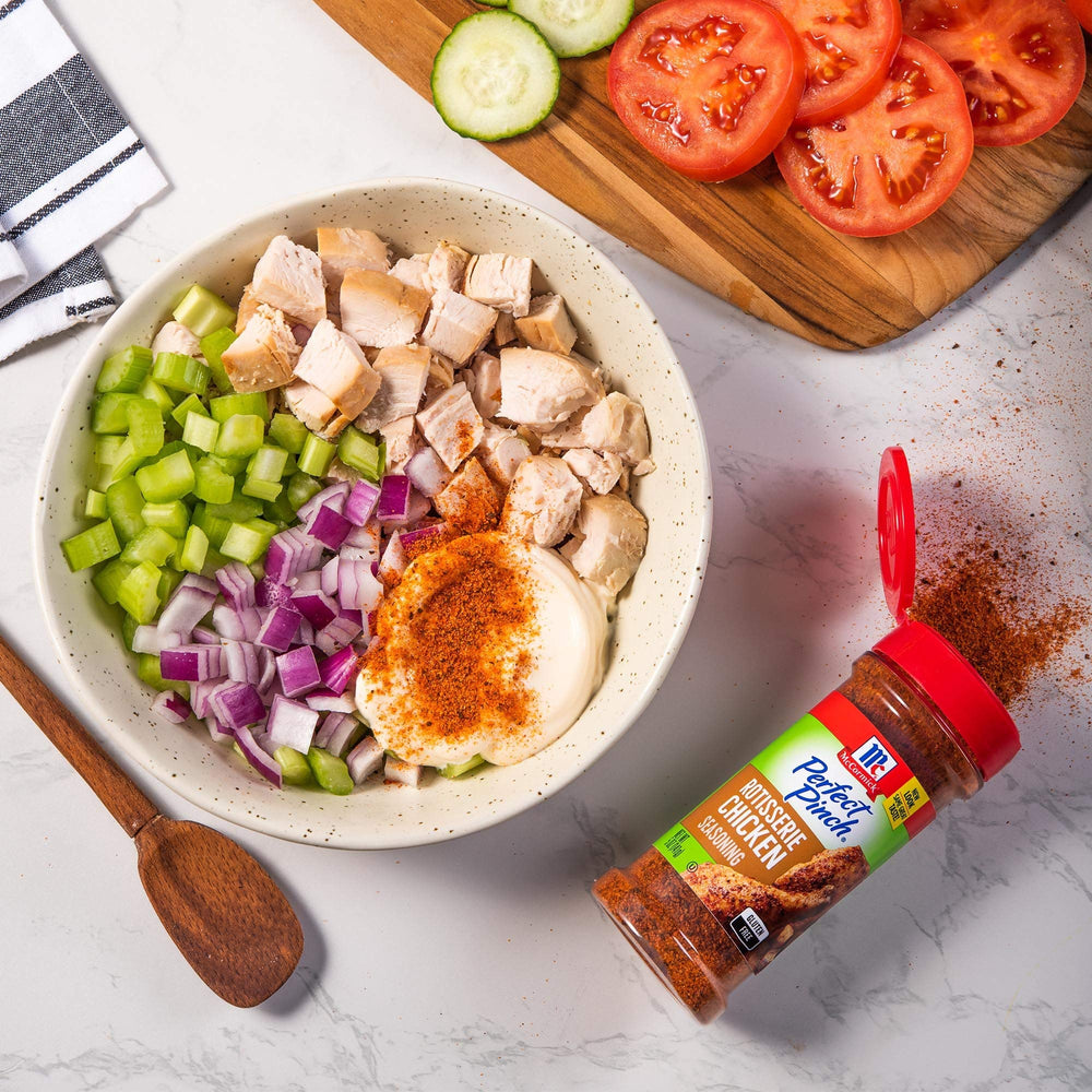 McCormick Perfect Pinch Rotisserie Chicken Seasoning on plate with roasted chicken