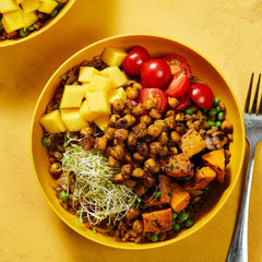Tabitha Brown Sunshine Seasoning jar featured beside peppers for Meatless Monday flavor.