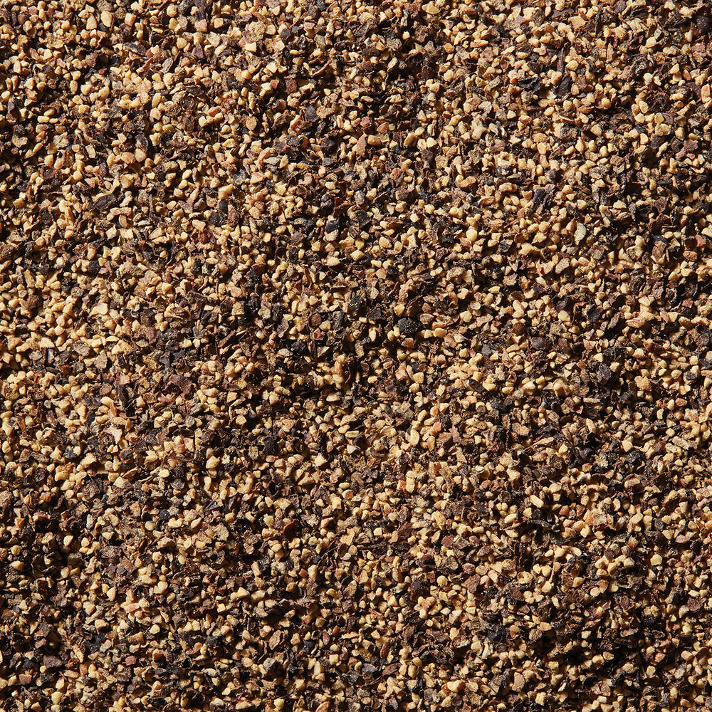 McCormick Table Grind Black Pepper label closeup, conveying hand-harvested bold flavor