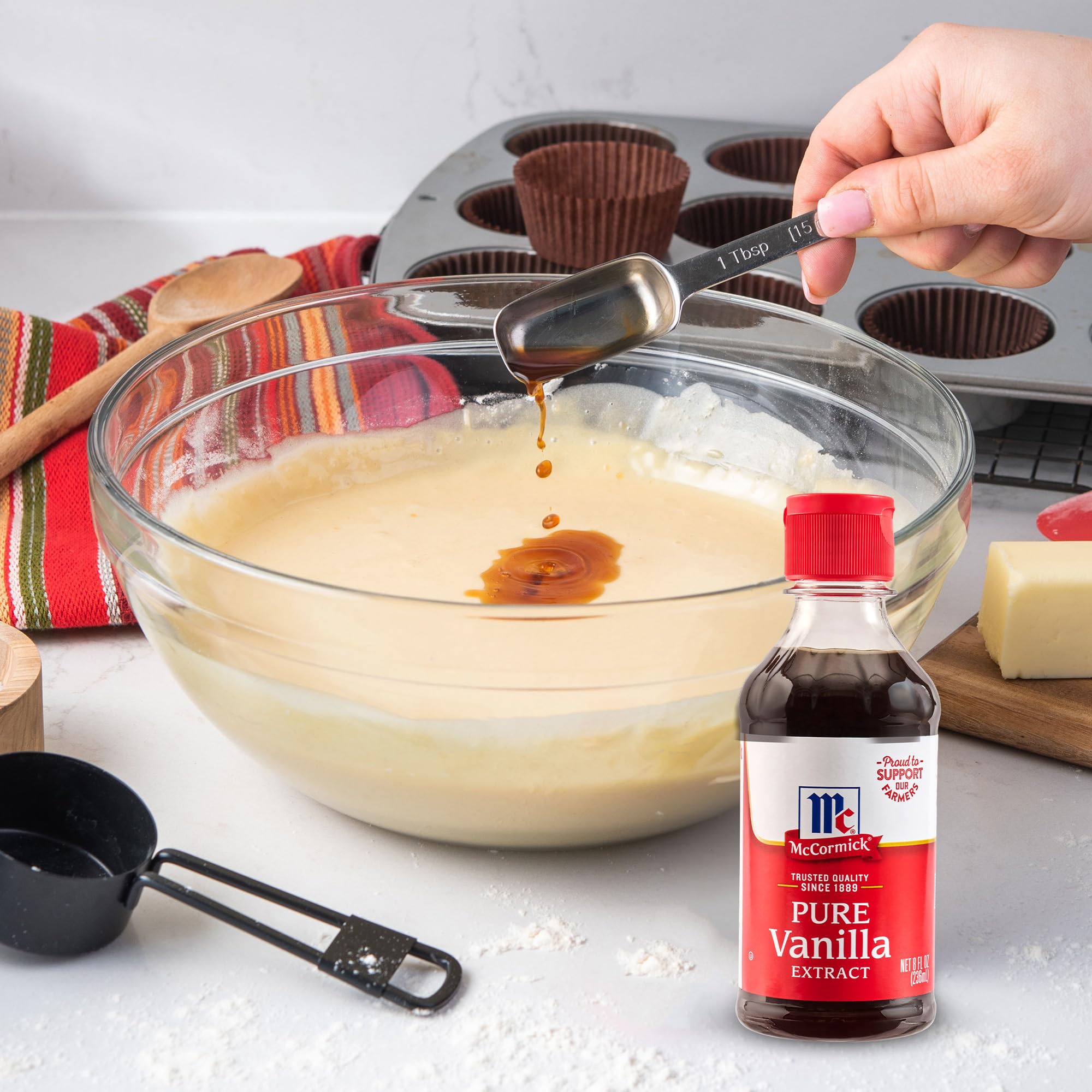 McCormick Vanilla Extract pouring into a mixing glass for desserts