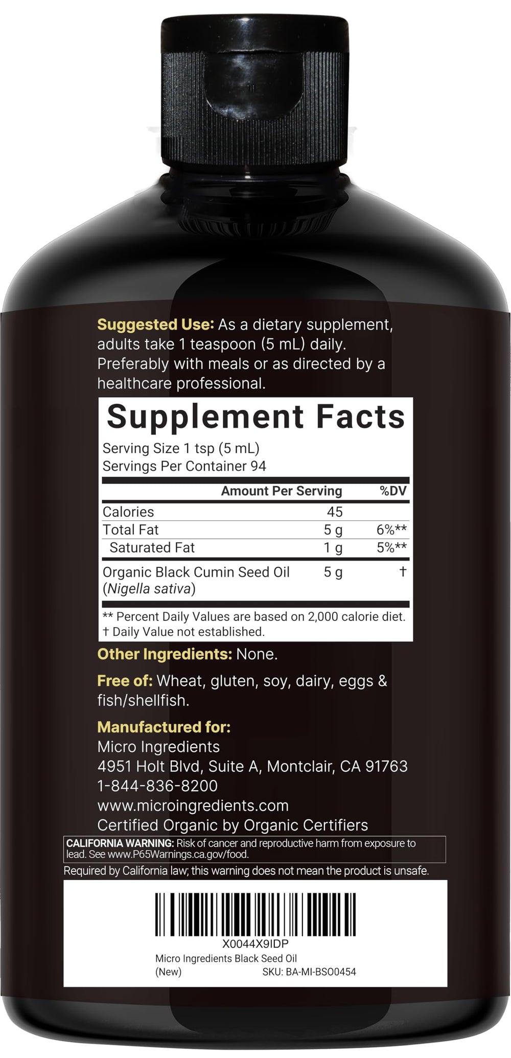Micro Ingredients Black Seed Oil bottle pouring into a spoon for recipes.