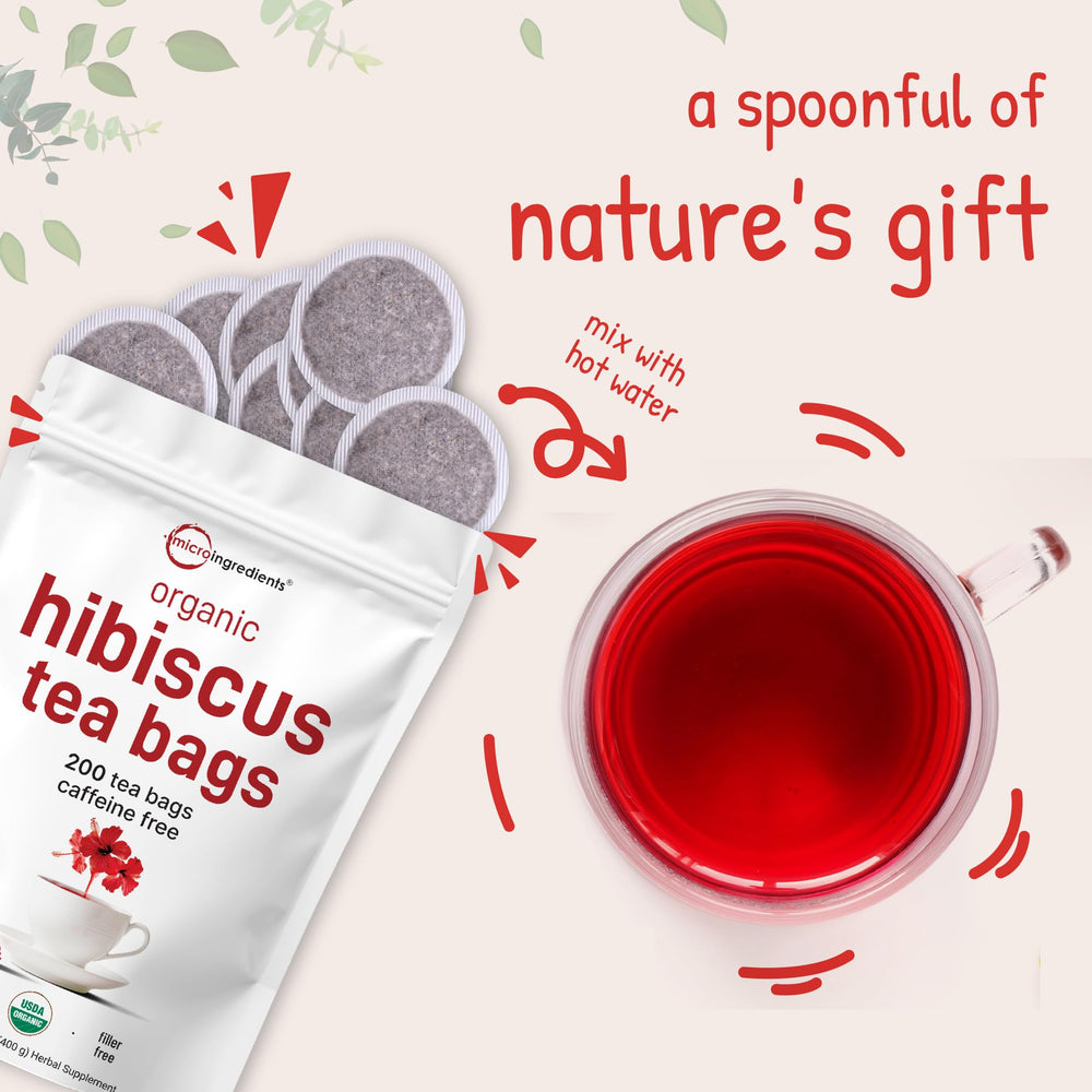micro ingredients steeped hibiscus tea amber color in glass cup, refreshing.
