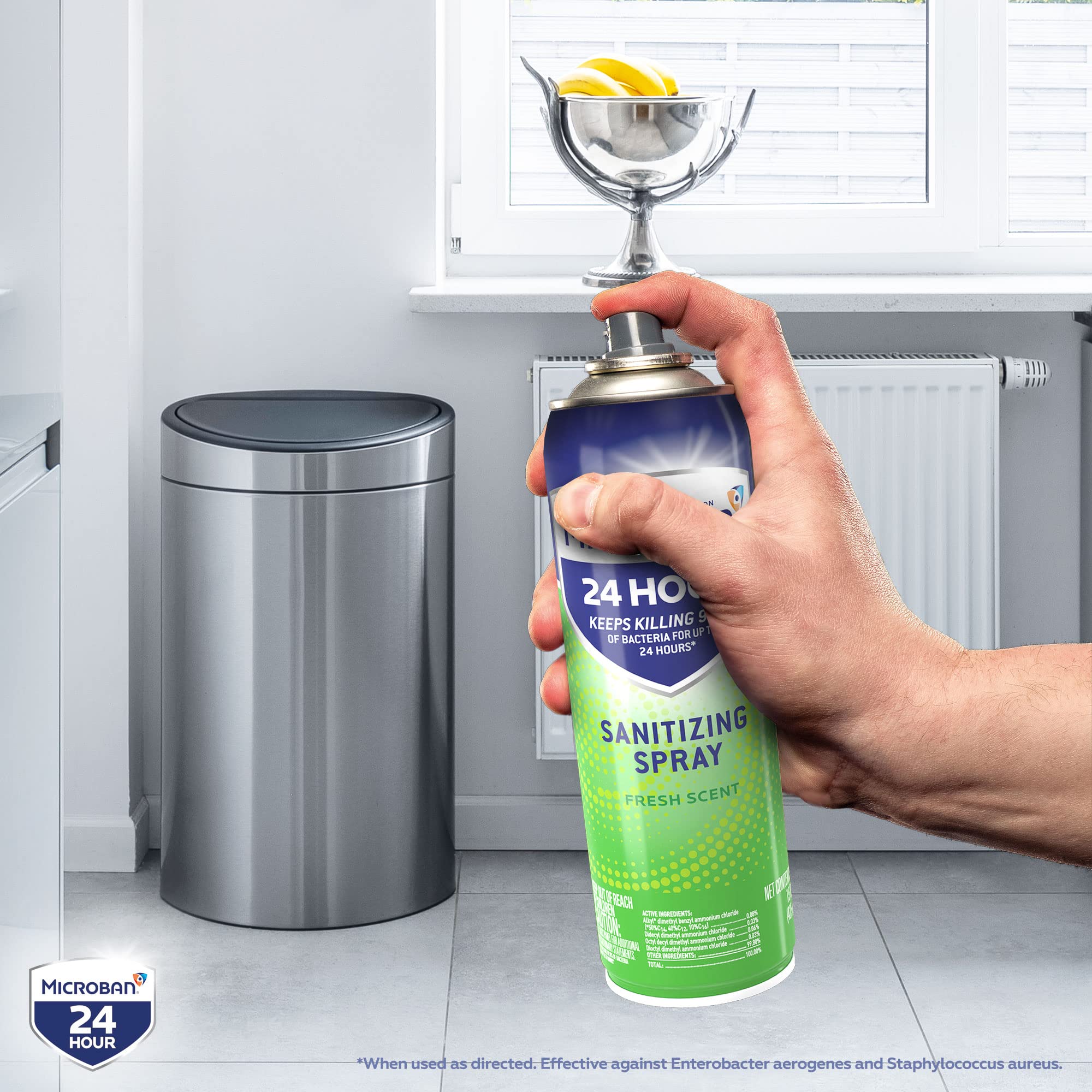Microban disinfectant spray being used on a door handle for sanitization.