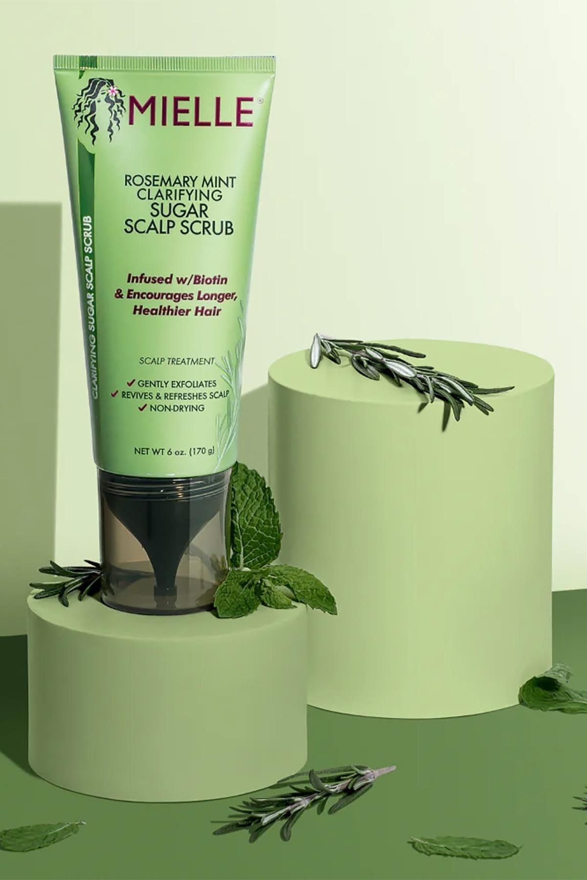 Mielle Organics rosemary and mint leaves highlight natural ingredients for a spa-like experience.