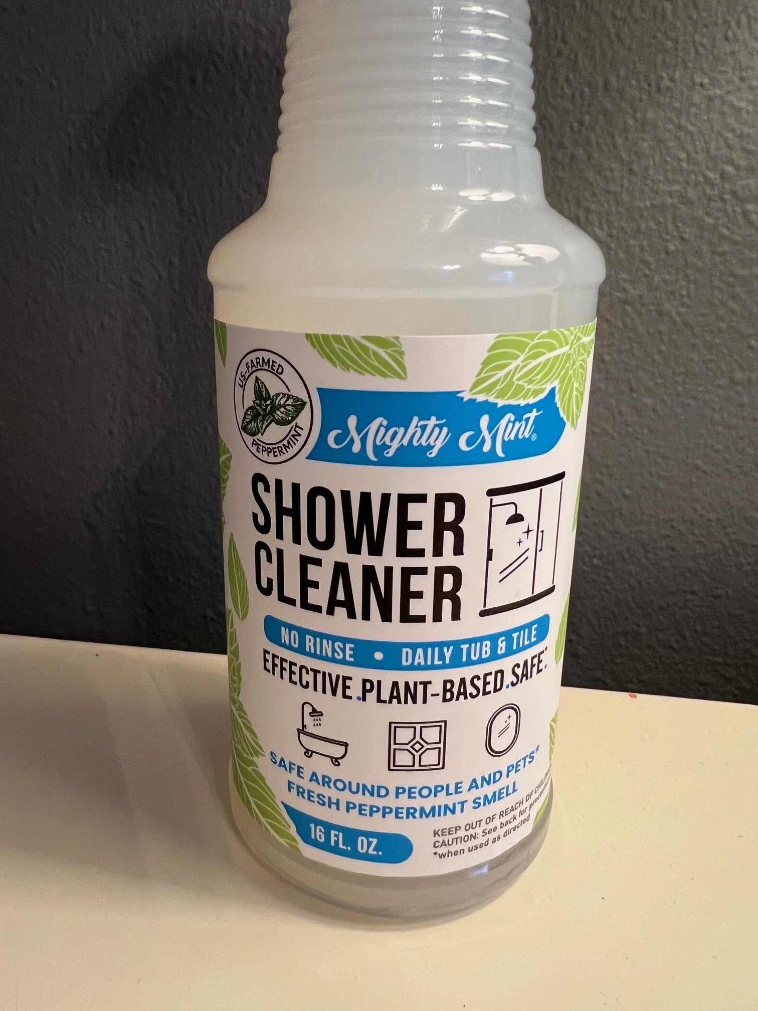 Mighty Mint bottle near stainless fixtures demonstrating easy cleaning