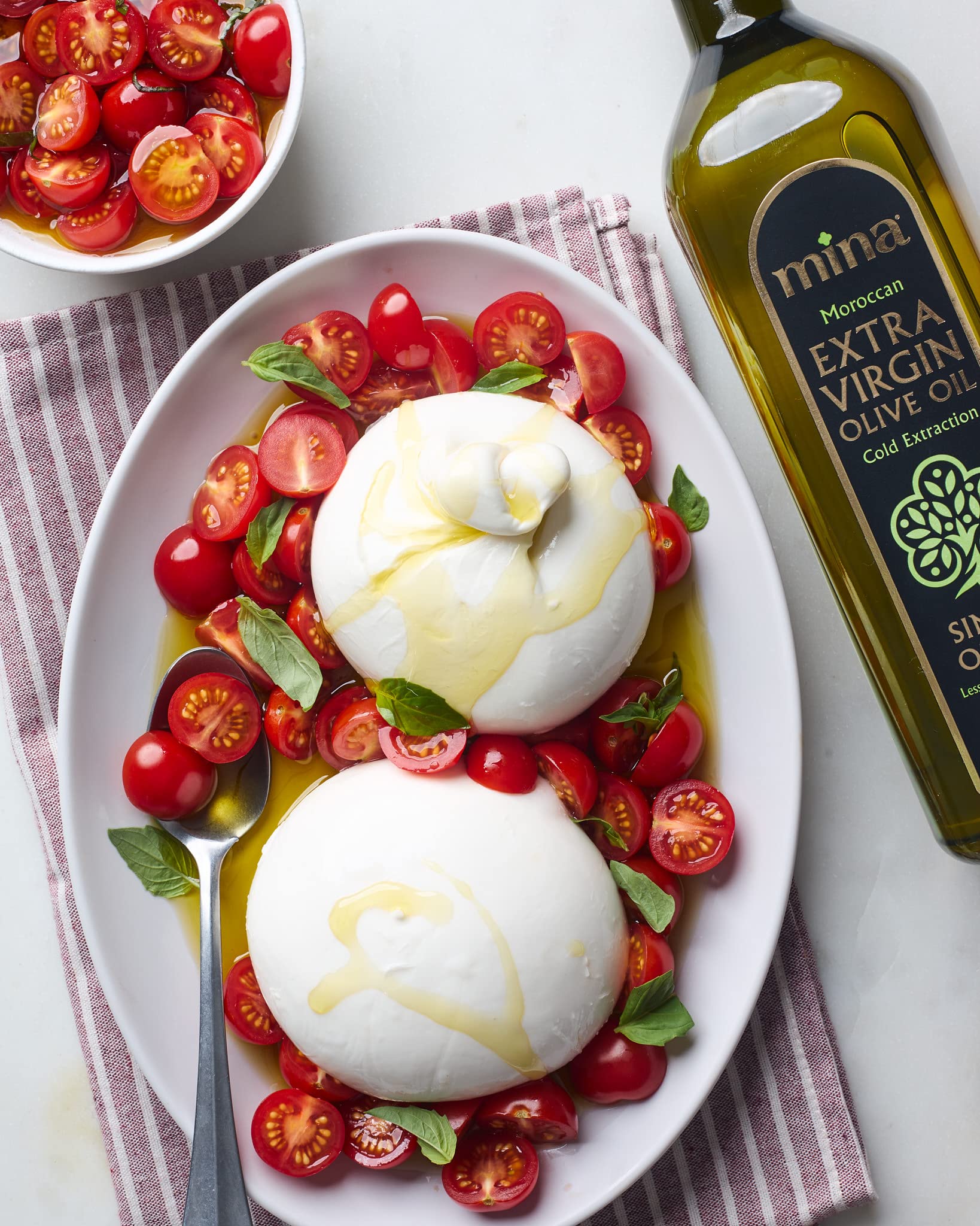 Mina olive oil in dressing bowl for finishing dishes.