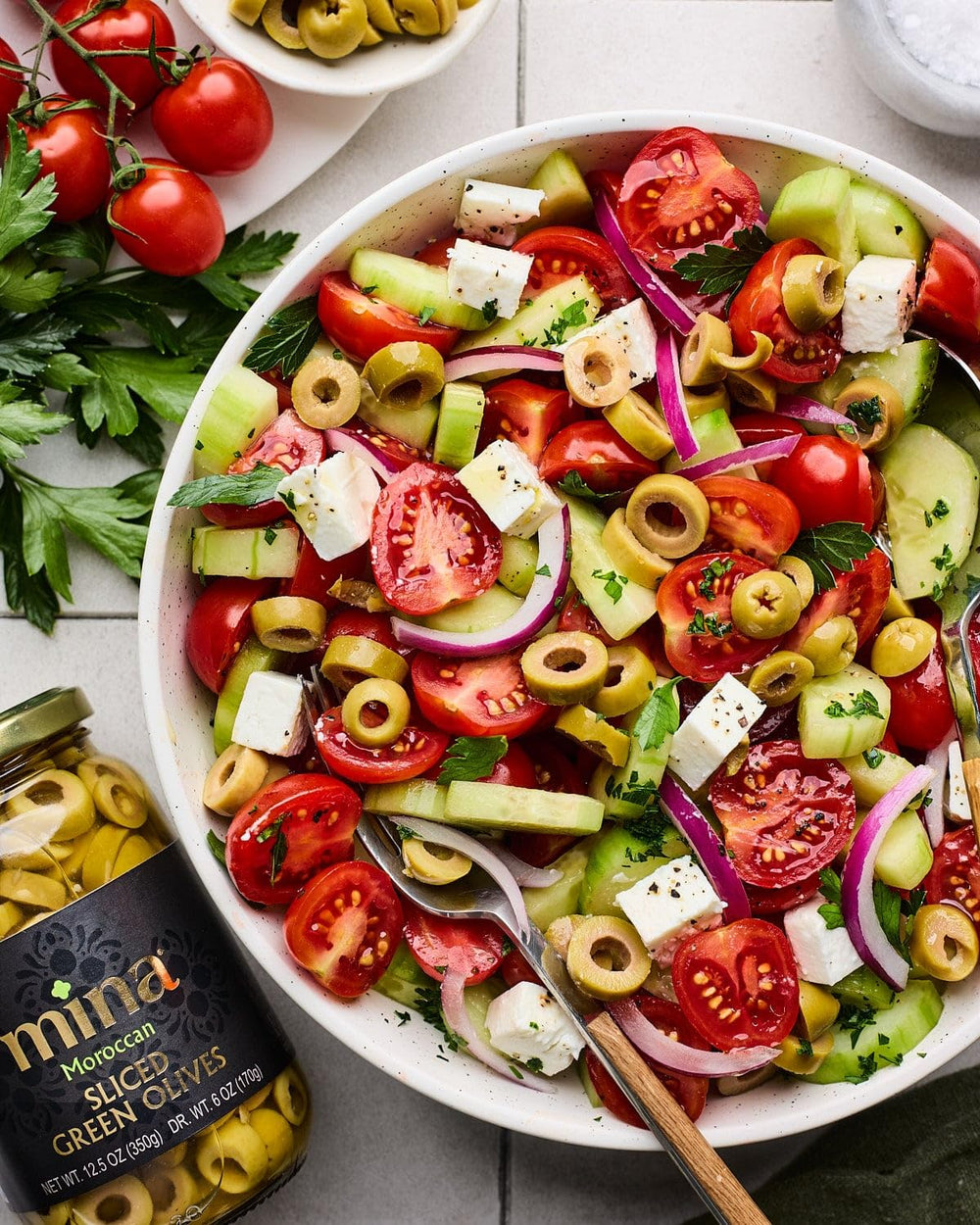 Mina Sliced Green Olives in a salad bowl adding brightness and tang