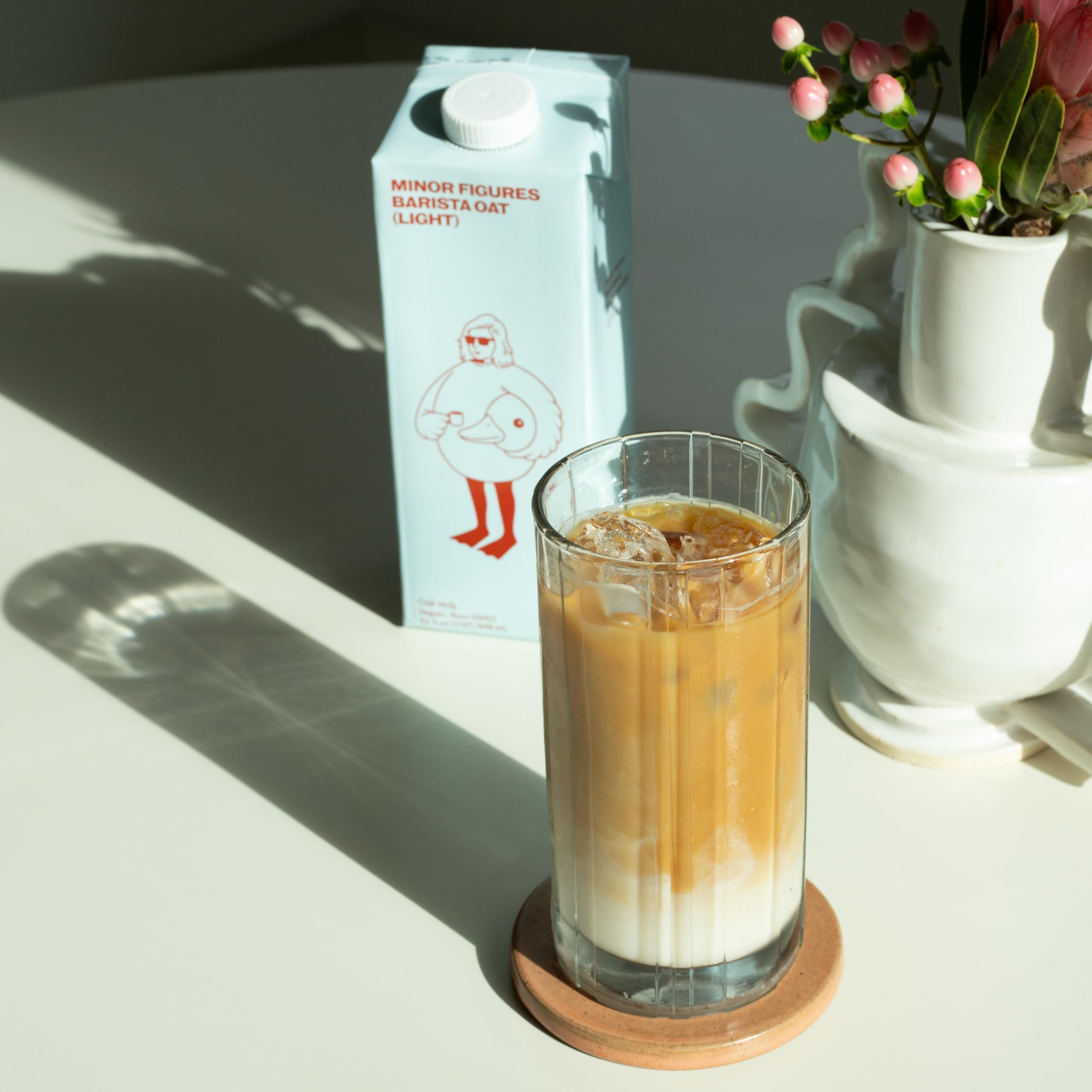 Shelf-stable oat milk stored in pantry for quick coffee moments.
