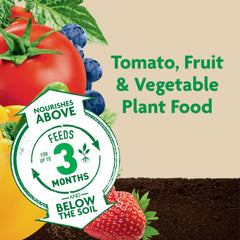 Sprinkling Miracle-Gro Shake 'N Feed onto soil for in-ground feeding