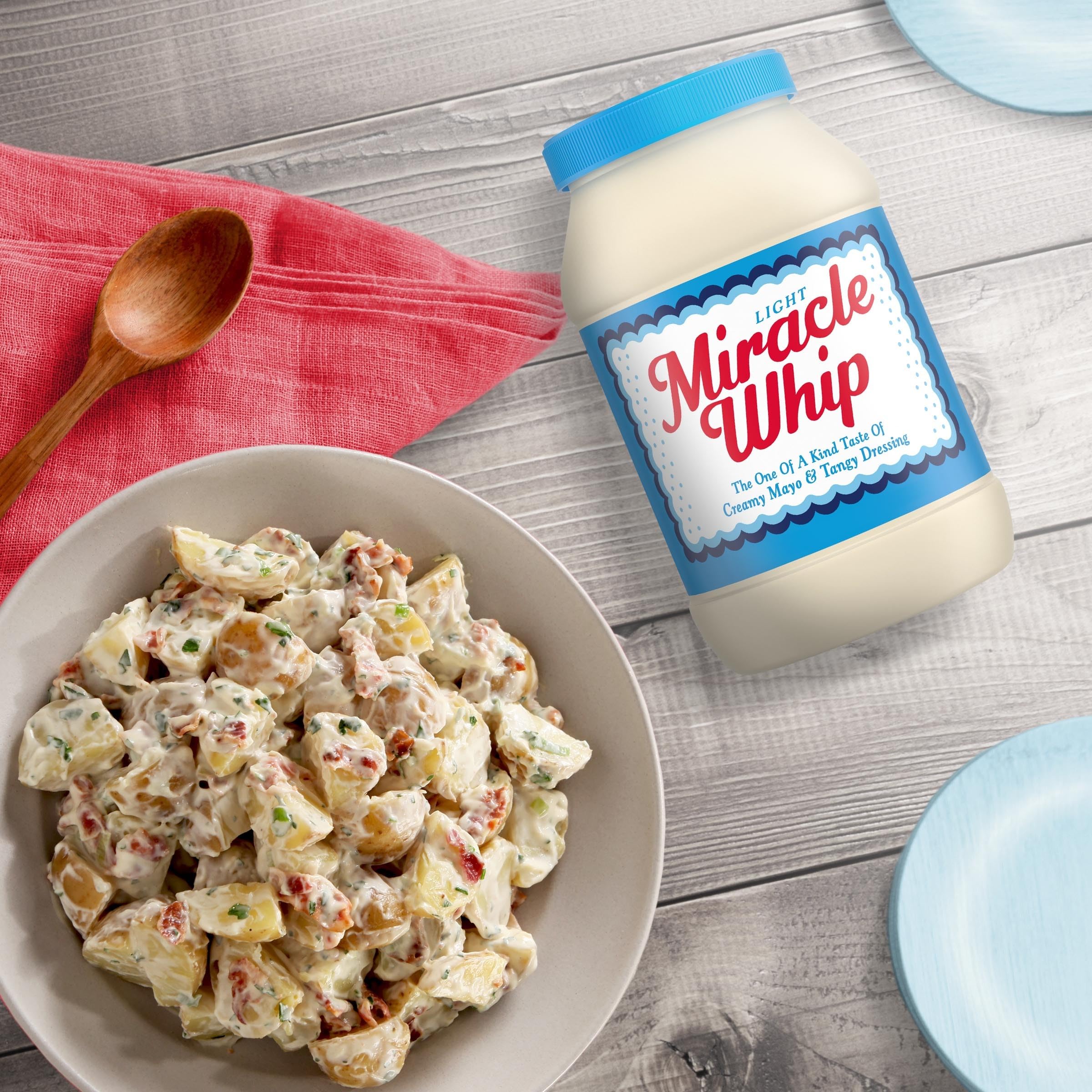 Miracle Whip Light dressing poured over salad in a bowl highlights creamy tang.