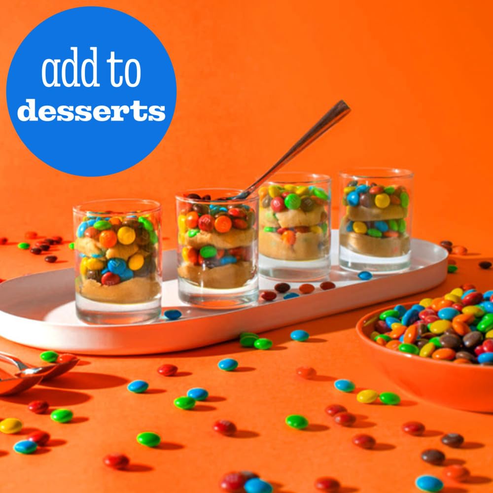 Detailed view of M&M's colorful candy shells on chocolate.