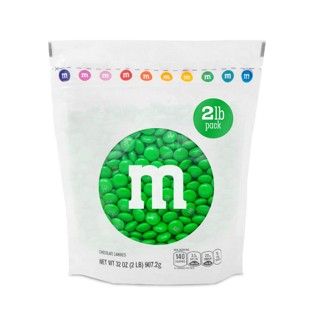 M&M'S WORLD green milk chocolate candy bag front, ideal for bulk party snacks.