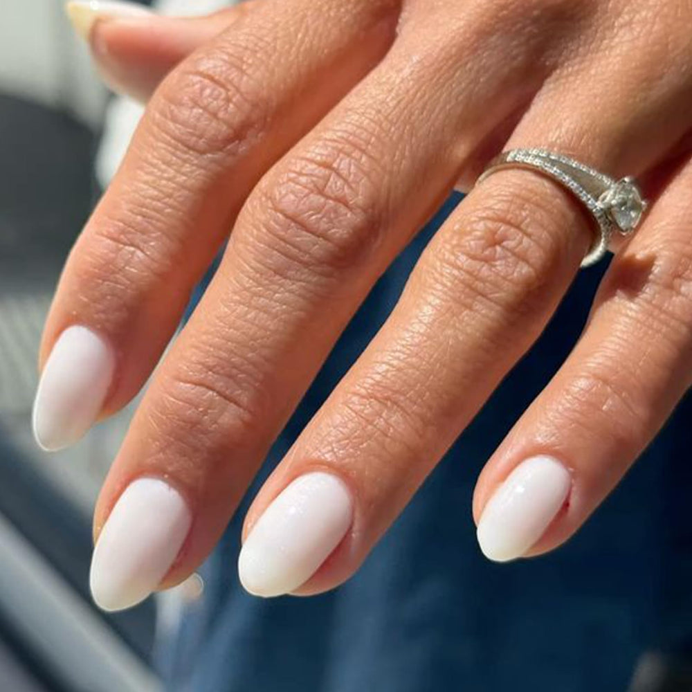 Modelones oval short press-on nails in milky white for fast, stylish manicures.
