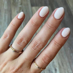 Modelones short press-on nails in oval white kit for quick, stylish manicure.