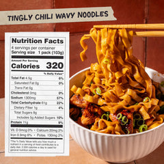 Open package of Momofuku Tingly Chili Noodles with sauce sachets
