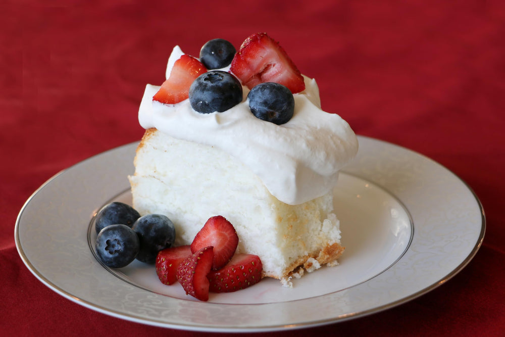 Mom's Place baked angel food cake slice plated, light and fluffy texture.