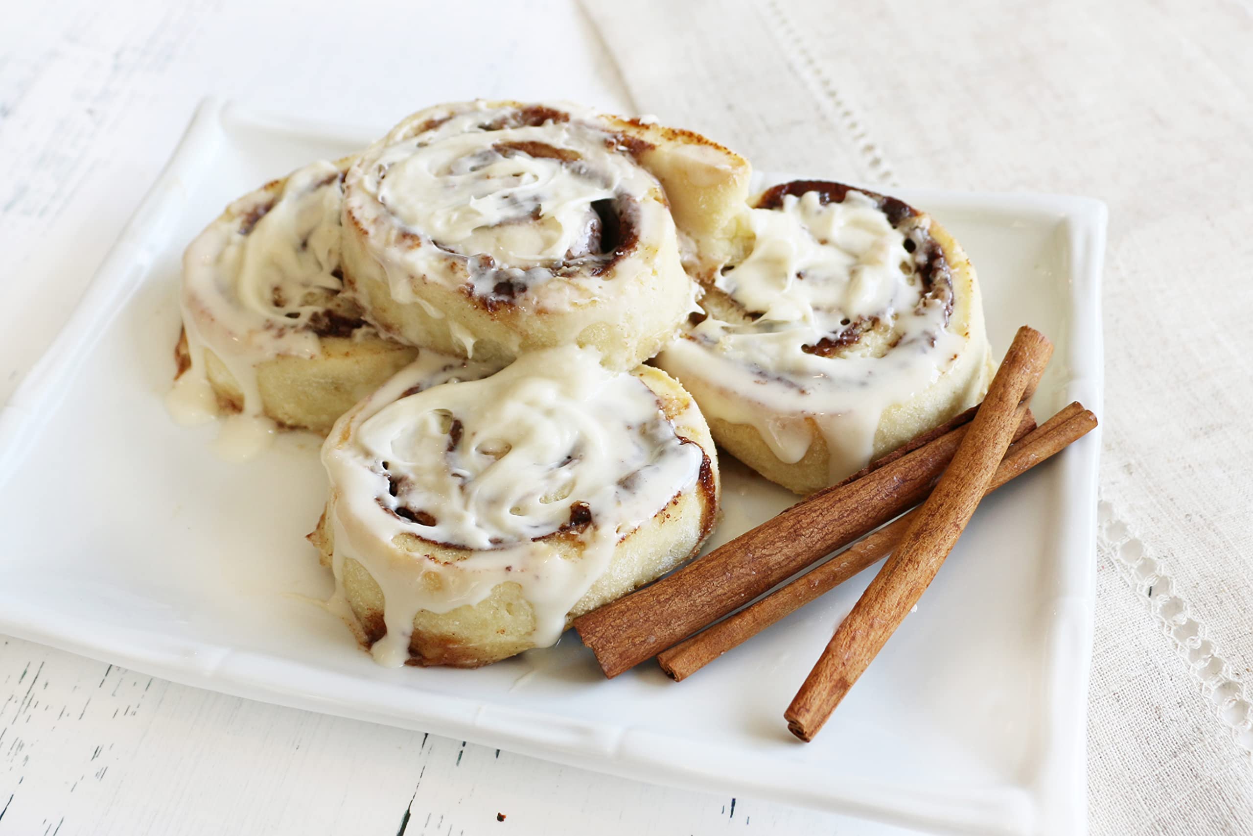 Mom's Place Gluten-Free cinnamon buns plated with sugar for breakfast.