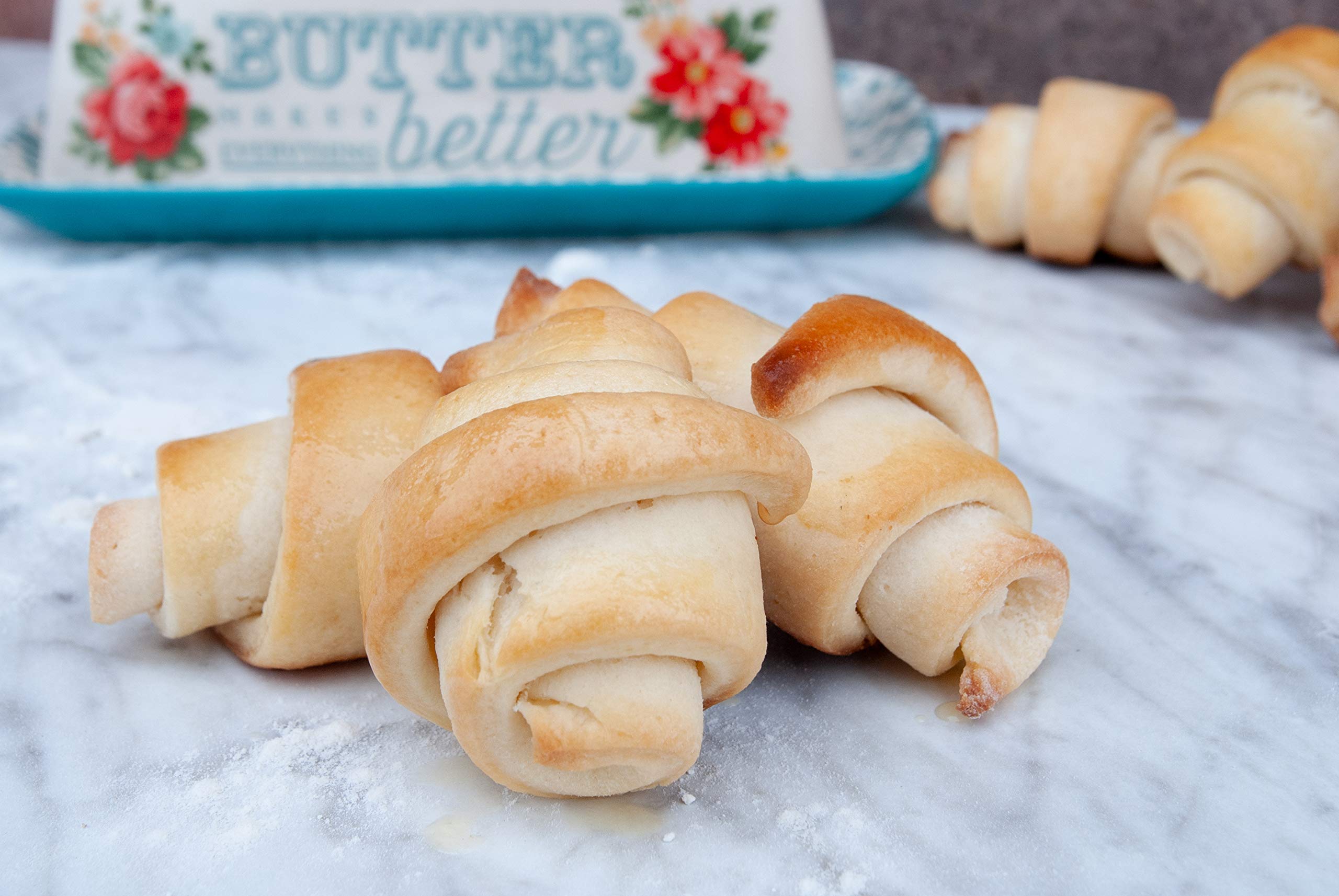 Family plates with crescent rolls made from Mom's Place Gluten-Free mix