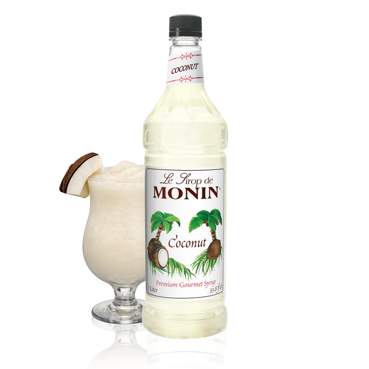 Monin Coconut Syrup bottle pouring into a tropical cocktail for island flavor.