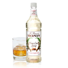 Monin Pure Cane Syrup bottle pouring into coffee for quick sweetness