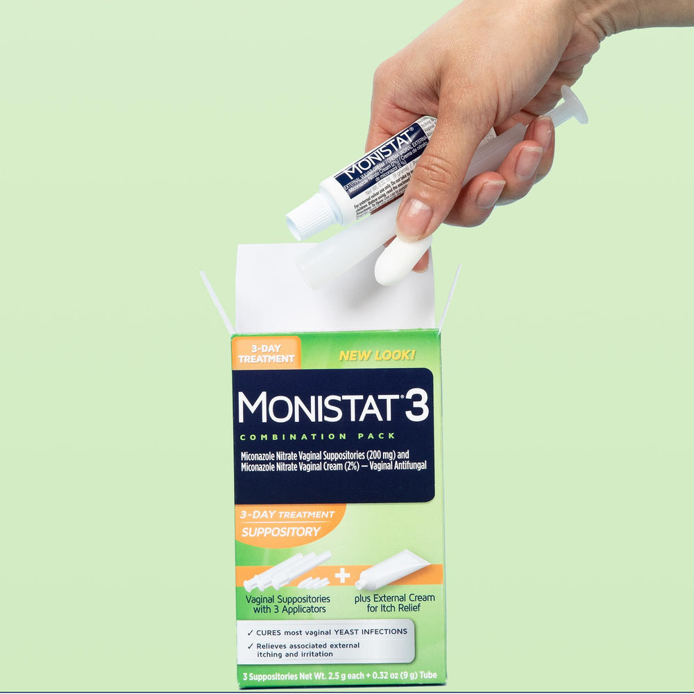 Person using a Monistat suppository with applicator for simple at-home care.