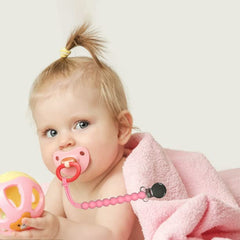 MORIBOX Paci Clip attached to a pacifier for quick reach.
