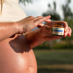 Applying Motherlove C-Section Cream to scar for gentle massage.