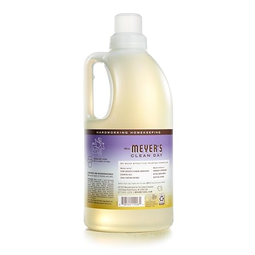 Pouring Mrs. Meyer's Compassion Flower detergent into a washing machine.