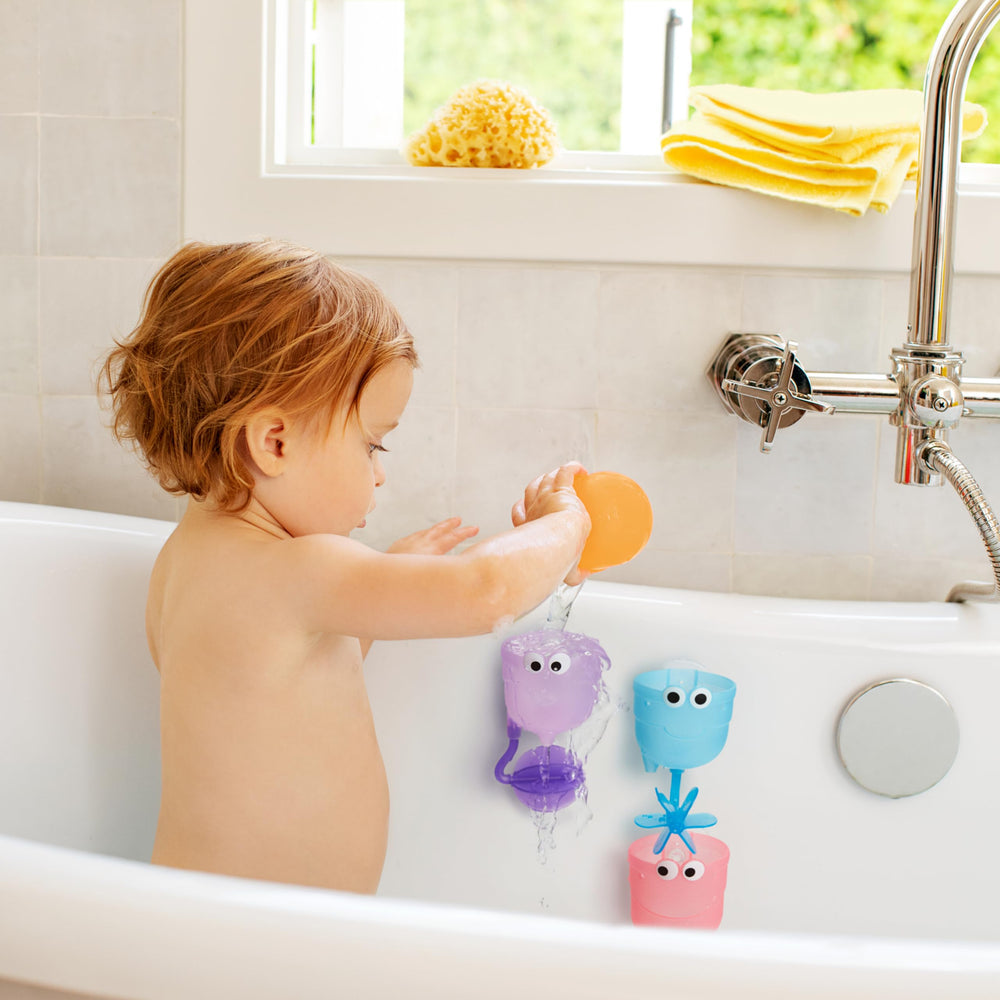 Child enjoys bath time with Munchkin Falls colorful cups