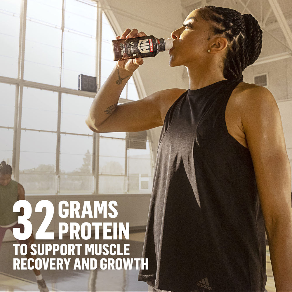 Muscle Milk Pro Knockout Chocolate shake in glass with creamy texture.