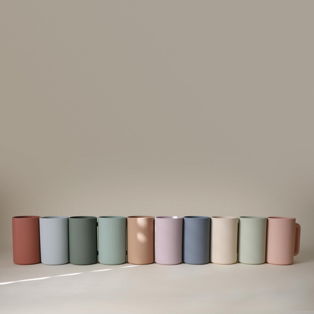 Mushie bath rinse cup adds calm design to any bathroom routine.