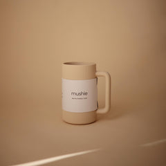 Mushie bath rinse cup shows textured exterior for secure grip while pouring.