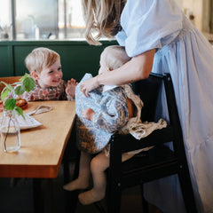 Mushie bib wide catch pocket catches crumbs to keep outfits cleaner