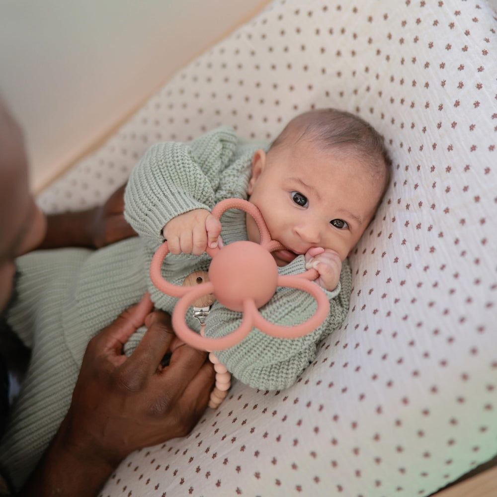 Mushie Daisy Rattle Teether safe silicone ideal for early teething exploration.