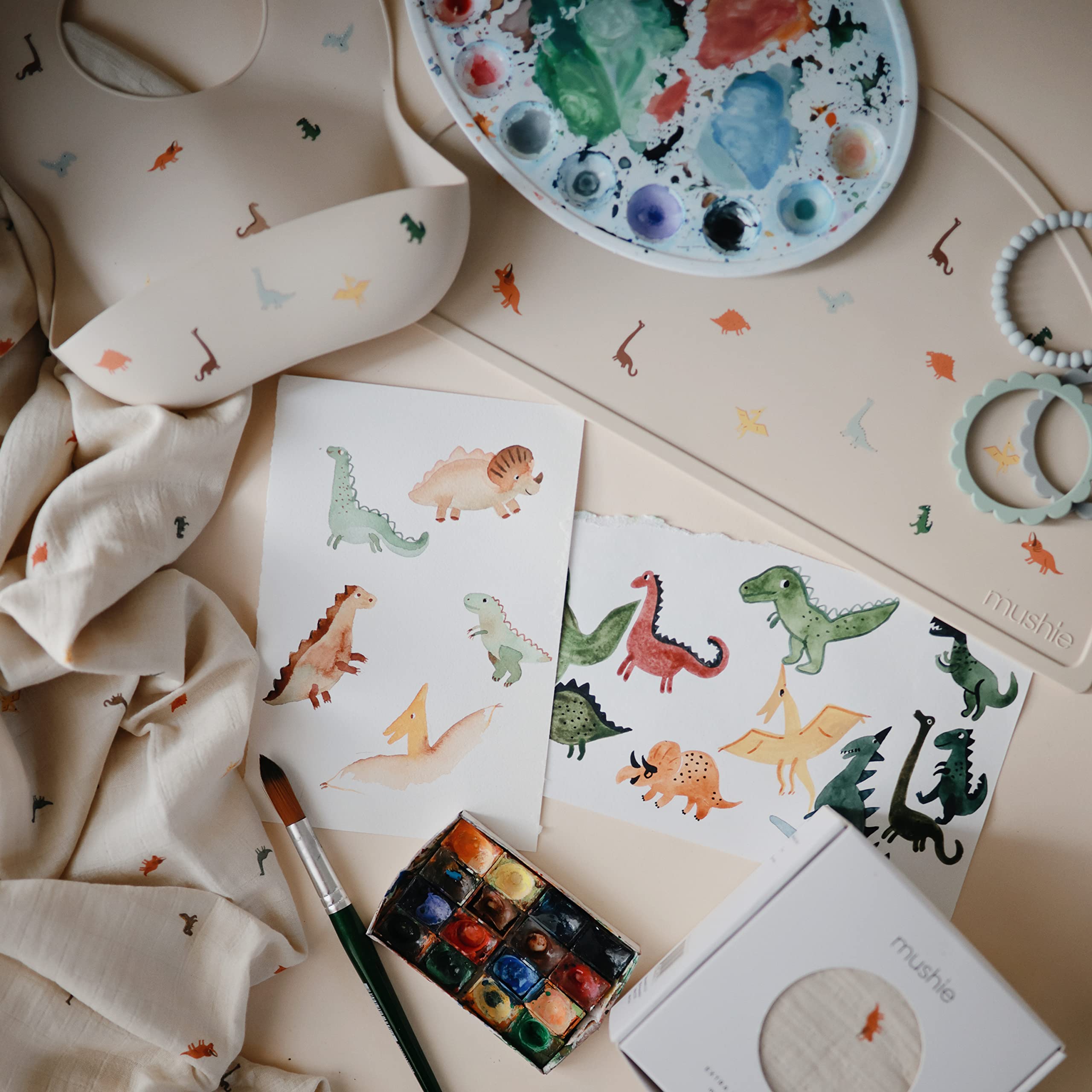 Mushie dinosaurs pattern bib designed in Sweden for timeless style.