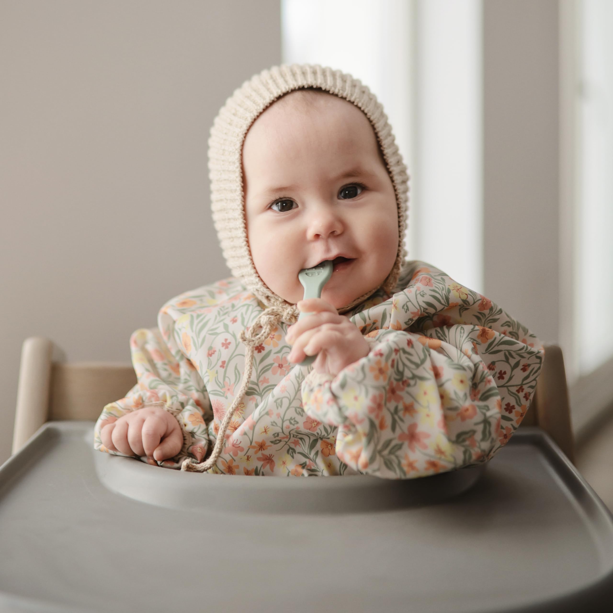 Mushie baby bib protects clothing while little ones explore new textures.