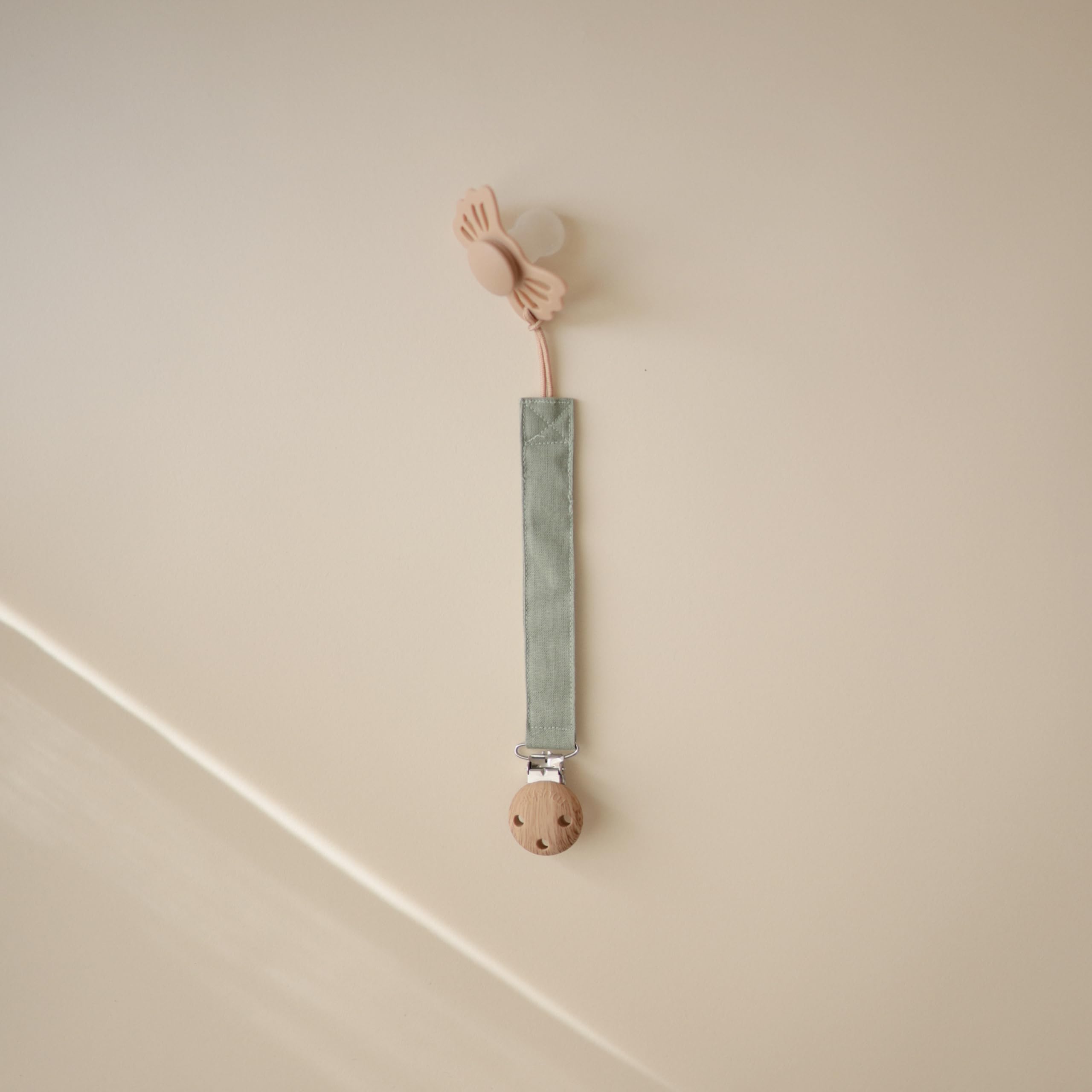 Mushie pacifier clip faux-wood clasp keeps pacifier within reach