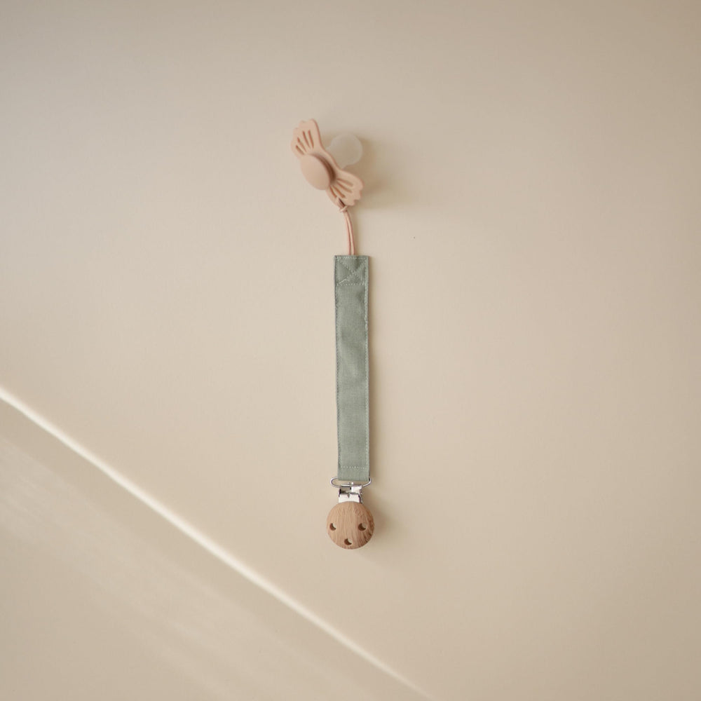 Mushie pacifier clip faux-wood clasp keeps pacifier within reach